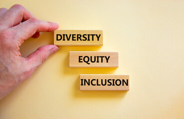 Diversity equity inclusion symbol. Concept words diversity equity inclusion on blocks on beautiful white table white background. Businessman hand. Business, diversity equity inclusion concept.