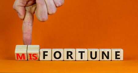 Fortune or misfortune symbol. Businessman turns wooden cubes and changes the concept word...