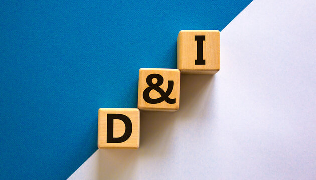 D and I, Diversity and inclusion symbol. Concept words D and I, diversity and inclusion on wooden cubes on beautiful blue table, white background. Business, D and I, diversity and inclusion concept.