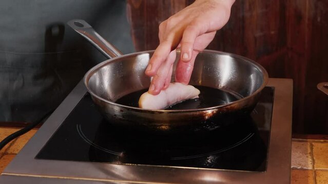 The chef on the stream prepares a dish of fried fish with broccoli and sauce