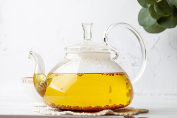 
Tea in a transparent teapot. Place for text. Buckwheat tea and granules.