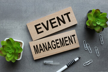 event management two wooden blocks on gray background business concept