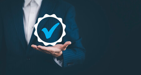 Quality assurance of business services, Businessman Hand shows the sign of the top service Quality assurance in Black background , Guarantee, Standards, ISO certification and standardization concept.