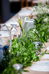 Wedding organization preparation restaurant and wedding planners.Chairs and honeymooners table decorated with candles, served with cutlery and crockery and covered with a table cloth. wedding area
