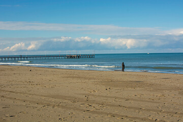 Man standing by the sea. Desperate, sad person. Loneliness theme.