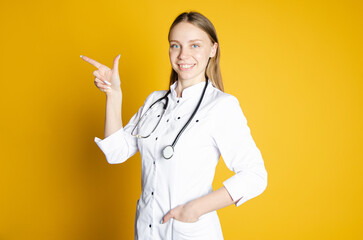 the girl doctor looks into the camera in a white coat. recording space