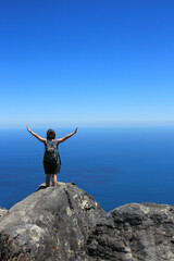 Freedom and success. A girl at the top of the Table Mountain in Cape Town, South Africa