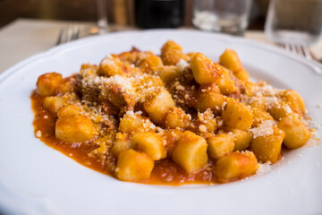 typical italian plate of gnocchi with meat and chese