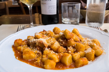 typical italian plate of gnocchi with meat and chese