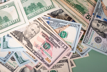 A lot of paper dollar bills on a green background. Financial and banking concept.