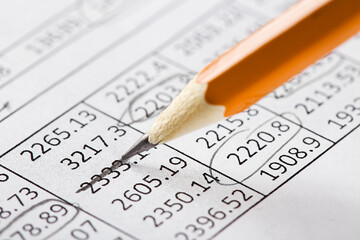 Accounting document with pencil and checking financial chart. Concept of banking, financial report and financial audit.