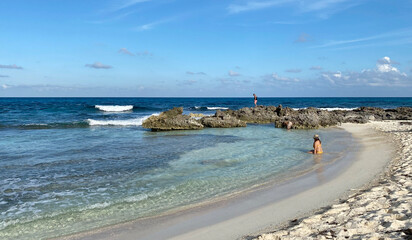 Woman sitting on the beach in Isla Mujeres, Mexico.