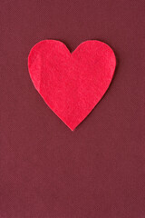 Obraz premium isolated felt heart on a fabric background