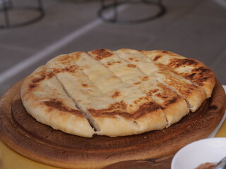 flat bread with colonnata lard served on a wooden cutting board