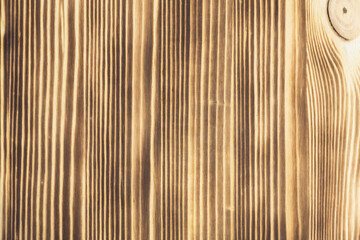 Wood with light and dark stripes.