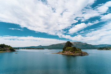 island in the lake with clouds 