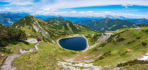 The panoramic view of blue alpine mountain lake Seekarsee lies at 2000 meters above sea level. High resolution panorama of a beautiful alpine summer wonderland at Flachau, Salzburg, Austria - 483488857