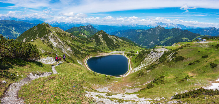The panoramic view of blue alpine mountain lake Seekarsee lies at 2000 meters above sea level. High resolution panorama of a beautiful alpine summer wonderland at Flachau, Salzburg, Austria