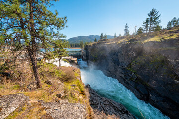 Mist rises from the dam along the Spokane River at Falls Park in the rural city of Post Falls, Idaho, USA.