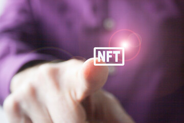 a man's finger pressing a virtual button as a concept of the new NFT paradigm - obrazy, fototapety, plakaty