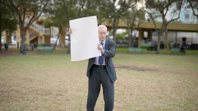 Businessman protesting with blank posterboard sign