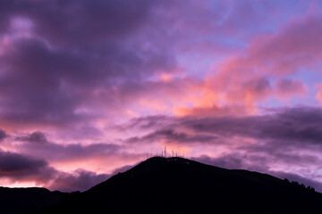 Pink sunset with Pichincha volcano silhouette, Quito, Ecuador.