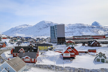 Nuuk city center streets with colorful Inuit houses covered in snow Nuuk with mountains in the background, Greenland © vadim.nefedov