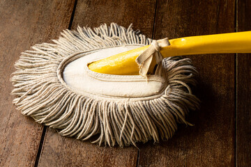 View of used handy mop on wooden floor. Handy mop is use to clean dust on the office table.