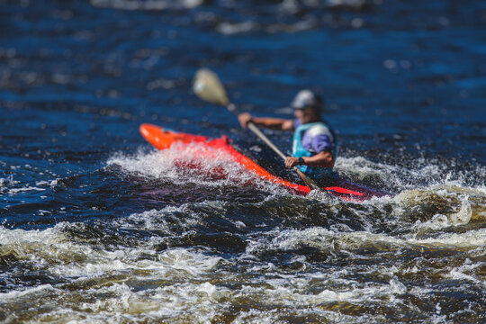 Kayak Slalom Canoe Race In White Water Rapid River, Process Of Kayaking Competition With Colorful Canoe Kayak Boat Paddling, Process Of Canoeing With Big Water Splash