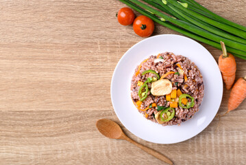 Fried purple rice with tofu, carrot, pumpkin and chili pepper. Healthy Asian vegan food, Table top view