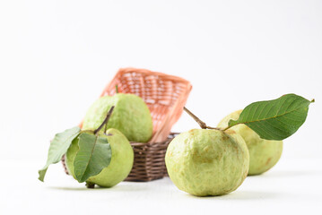 Fresh organic guava fruit in basket on white background, Tropical fruit