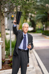 Photo of a businessman flagging down his Uber or Lyft ride request