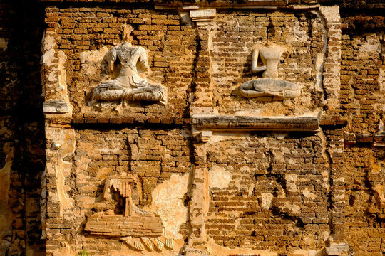 Old stucco Buddha and angel figures on the outside of the Maha Chedi of Wat Chet Yot (Wat Jed Yod) or Wat Photharam Maha Vihara, the public Buddhist temple. Located in Chiang Mai, Thailand.