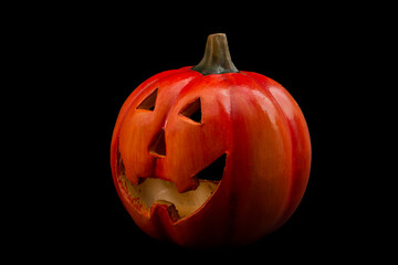 Happy Halloween, trick or treat and evil smile concept with a grinning jack-o-lantern pumpkin isolated on a black background and clipping path cutout