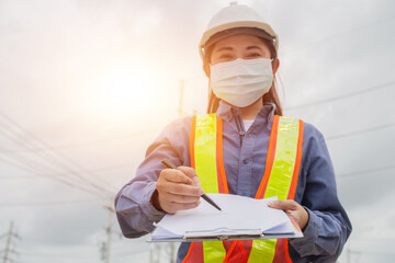 Asian women electrical engineer work on site service