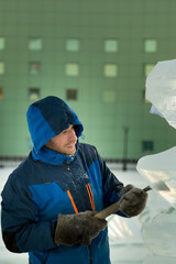 Portrait of a sculptor at work on a figure