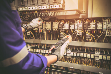 Electricity and electrical maintenance service, Engineer using measuring equipment tool checking...