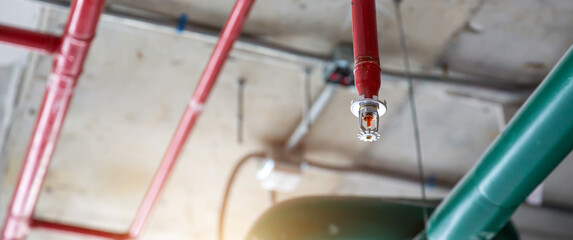 Close-up fire sprinkler on the ceiling for fire detection and alarm system equipment in building safety security protect and prevent or prevention when heat or flame detector is alert. - obrazy, fototapety, plakaty