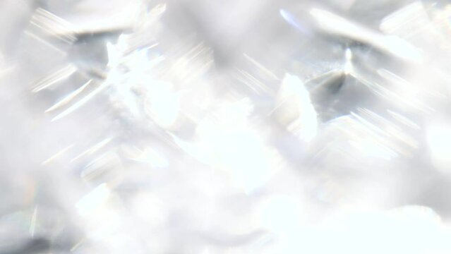 Sparkling diamond highlights backdrop. Light passes thru prism creating repeating light sparks. Dreamy, defocused glass refraction overlay