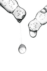 Transparent pipettes with cosmetics on a white isolated background.