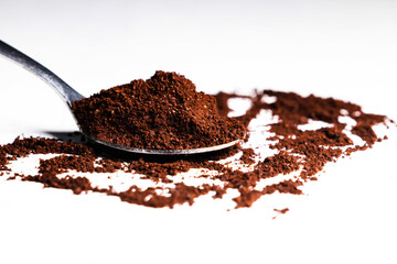 Selective focus and close up image of a spoon of ground coffee powder