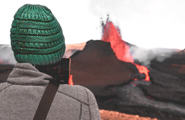 View of fagradalsfjall Volcano with Girl in green hat watching eruption in Iceland 