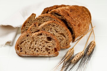 Slices of sourdough bread on wooden board. Healthy food. Artisan bread crumb texture.