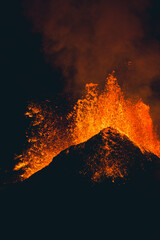 Orange Lava Splattering and Erupting out of Volcano at Night in Iceland