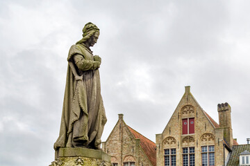 Fototapeta na wymiar statue of Jacob van Maerlant, Flemish poet and author of the 13th century, in Markt square of Damme, Belgian province of West Flanders, Belgium