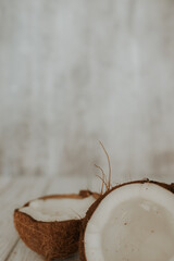 Two halves of a coconut lie on a light background.