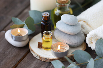 Assortment of natural oils in glass bottles on wooden background. Concept of pure organic ingredients in cosmetology. Bath accessoiries, atmosphere of harmony, relax. Close up macro. Healthy lifestyle
