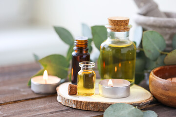 Fototapeta na wymiar Assortment of natural oils in glass bottles on wooden background. Concept of pure organic ingredients in cosmetology. Bath accessoiries, atmosphere of harmony, relax. Close up macro. Healthy lifestyle