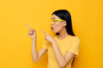 Obraz premium Charming young Asian woman hands gesture emotions cropped view yellow background unaltered