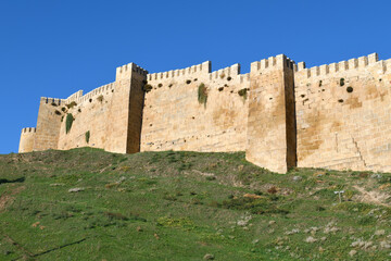 Fototapeta na wymiar Fortress wall with towers on a sunny September day. Ancient fortress of Naryn-Kala in Derbent. Republic of Dagestan, Russian Federation